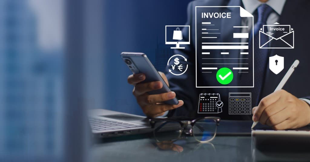 Business professional using a smartphone and laptop with digital invoice icons for FBR digital invoicing