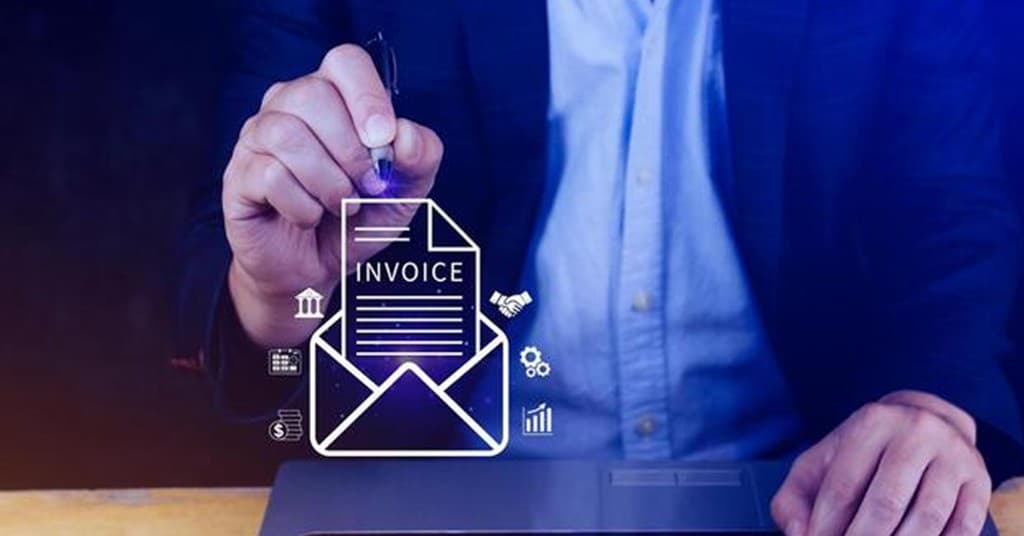 Business professional signing a digital invoice with a stylus on a laptop